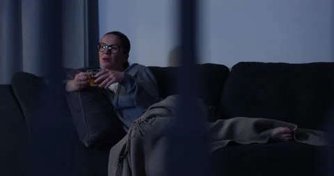 Tired woman watching TV at night 4K 4K+ 5K, RED camera footage Stock Footage 129453291