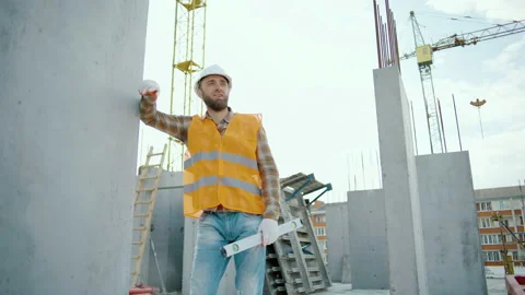 A tired worker at a construction site rests his hand on the wall Video stock 247770304