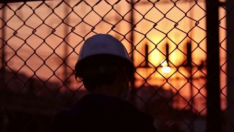A tired worker at a construction site at sunset. Stock Footage 169286449
