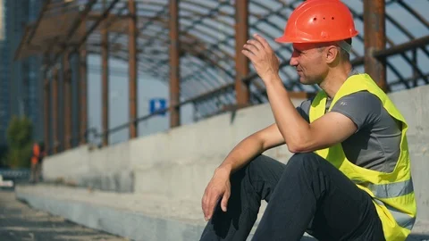 A tired worker at a construction site is upset after hard work Stock Footage 115907747