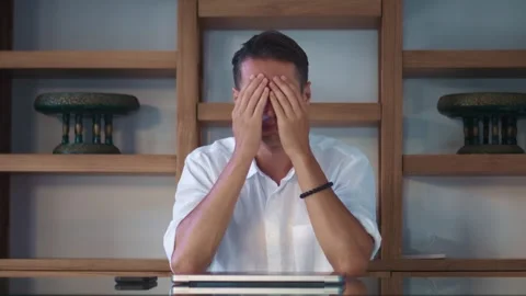 Tired worker leaning on office desk. Businessman concentrating on his laptop Stock Footage 312746292