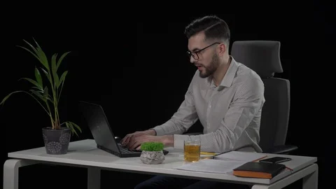 Tired of working young bearded man puts off his glasses and rubbs his eyes. Stock Footage 128524167