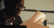 Tired Young Black Businessman Working With Documents At Night Office. Business Stock Footage