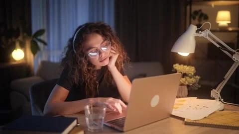 Tired young curly-haired freelance woman feeling annoyed during study or work at Stock Footage 256233845