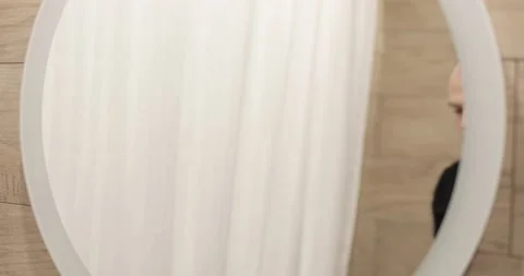 Tired young man is looking at mirror and washing face in morning in bathroom. Stock Footage 137438231