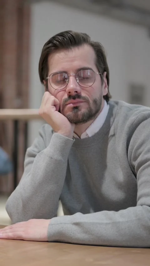 Tired Young Man taking Nap While Sitting in Office, Vertical Video Stock Footage 339581030