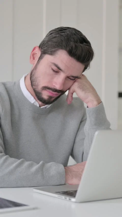 Tired Young Man taking Nap While Sitting in Office with Laptop, Vertical Video Stock Footage 339582006