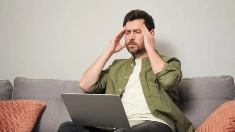 Tired young overworked man worker feel fatigue suffer from eye strain headache. Stock-Footage 230909503