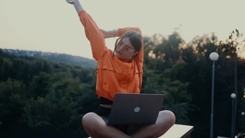 The tired young student takes a break from classes, raises her hands, stretches Stock-Footage 201875665