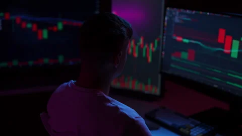 Tired young trader man experiencing headache while analyzing graphs on computer Stock Footage 294714405