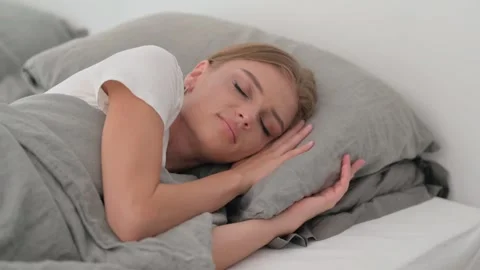 Tired Young Woman Sleeping while Lying on Side in Bed Stock Footage 287901022