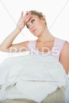 Tired young woman with stack of clothes Stock Photos