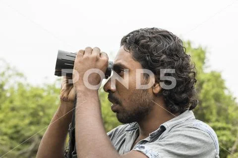 TISSAMAHARAMA, SRI LANKA, Safari guide looks out for animals Stock Photos
