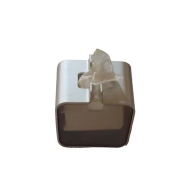 A tissue box is covered in a white plastic material with a single tissue Stock Photos