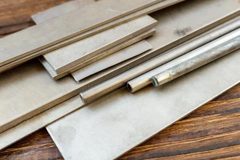 Titanium alloys plates bars pins stock hole tubing thong sheet for knife hand Stock Photos