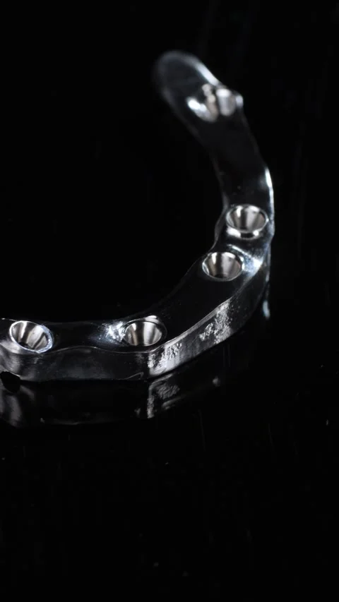 Titanium dental framework arch on black backdrop Video stock 321488716