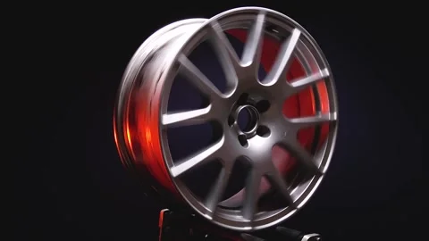 Titanium rims in silver color in red light in dark Video stock 258656001