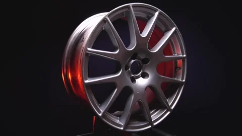 Titanium rims in silver color in red light in dark Stock Footage 258656010