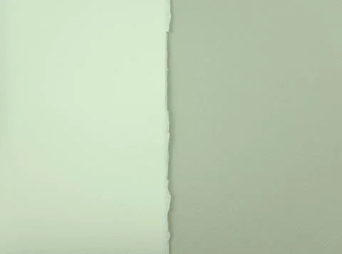 Titanium white matte paper with unique torn of the side on light gray paper.. Stock Photos