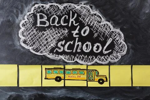 The title "Back to school"  written by white chalk on the black chalkboard an Stock Photos