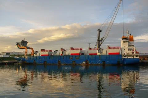 Title: Cargo Ship Carrying Large Wind Turbine Nacelles at Industrial Port H.. Stock Photos
