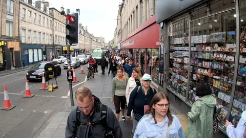 Title Crowded Edinburgh sidewalk with traffic during Fringe festival Stock Footage 346411198