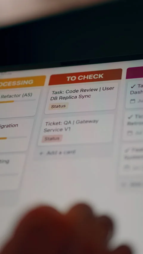 Title: Developer Reviewing Agile Task Board and QA Tickets on Tablet Video stock 341570337