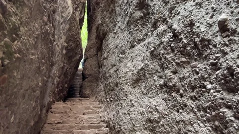 Title Moving Up Narrow Stone Steps in Deep Canyon Cleft Stock-Footage 335858007