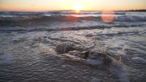Title Stunning golden sunset glowing brightly over peaceful ocean water waves Stock Footage 340330716
