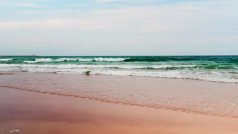 Title: Sunny Beach and Ocean Waves with Surfers in Portugal Видео 336729297