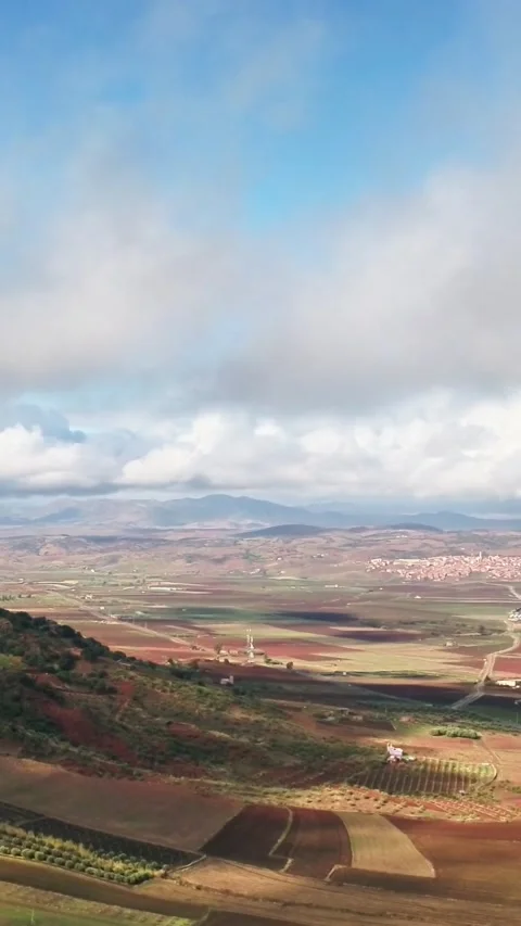Title Vertical Aerial of Red Soil Farmland and Low Clouds Middle Atlas 動画素材 333152185