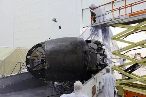 TITUSVILLE, Fla. - Technicians unpack the Tracking and Data Relay Satellit... Stock Photos