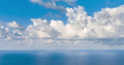 TL - Clouds moving above the ocean against clear blue sky Stock Footage 85370102