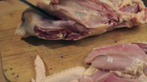 TL Cook cut up raw turkey into pieces with a knife Stock Footage 2923584