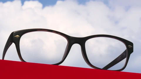 T/L Glasses on Red table with time lapse view of clouds moving Stock Footage 164007732