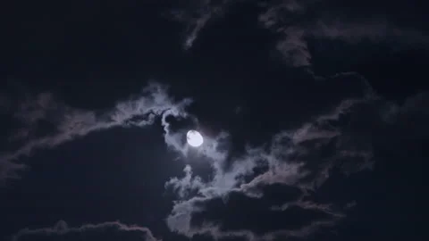 T/L Half moon behind clouds at night Stock Footage 162591320