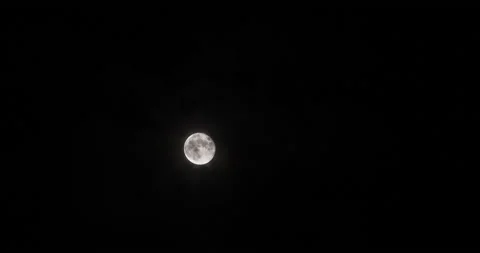 T/L Move moon across the frame in cross light clouds Stock Footage 162591078