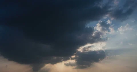 T/L Moving and changing clouds at the sky with sunbeam Stock Footage 162584944