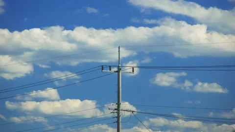 T/L Telegraph pole with clouds moving in timelapse scene Stock Footage 162597946