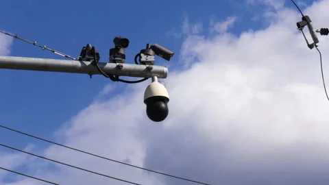 T/L Time lapse low angle view of security camera with blue sky and clouds m Stock Footage 166829324