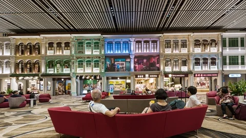 TL/ZI/ Time lapse of people inside Changi airport departure lounge Stock Footage 116569516