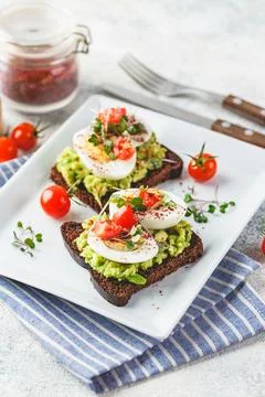 Toast with avocado and egg Stock Photos