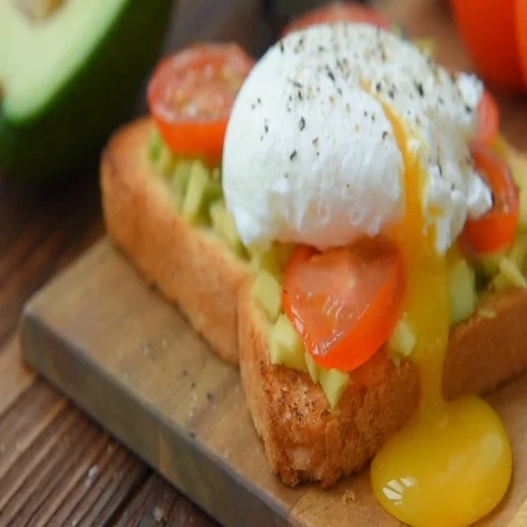 Toast with avocado , egg and tomatoes cooked in olive oil Stock Footage 69600326