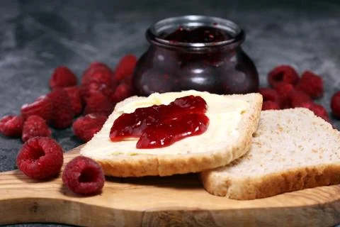 Toast bread with homemade raspberry jam or marmalade on rustic table served w Stock Photos