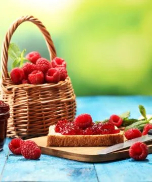 Toast bread with homemade raspberry jam or marmalade on table served with but Stock Photos