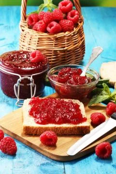 Toast bread with homemade raspberry jam or marmalade on table served with but Stock Photos