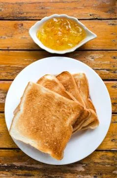 Toast bread with orange jam Stock Photos