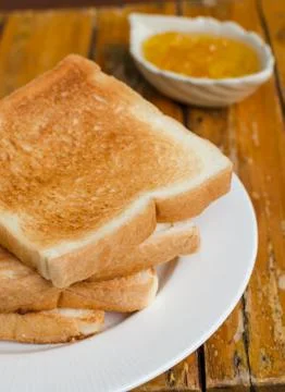 Toast bread with orange jam Stock Photos