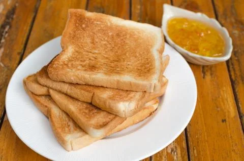 Toast bread with orange jam Stock Photos