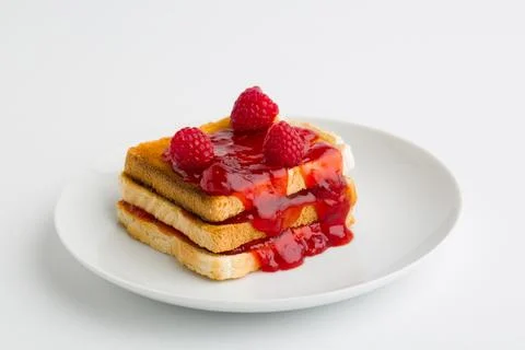Toast bread with raspberry jam on plate Stock Photos
